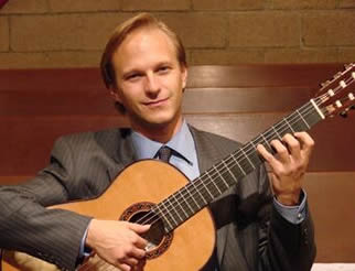 Photo of Edward Trybek and his guitar.